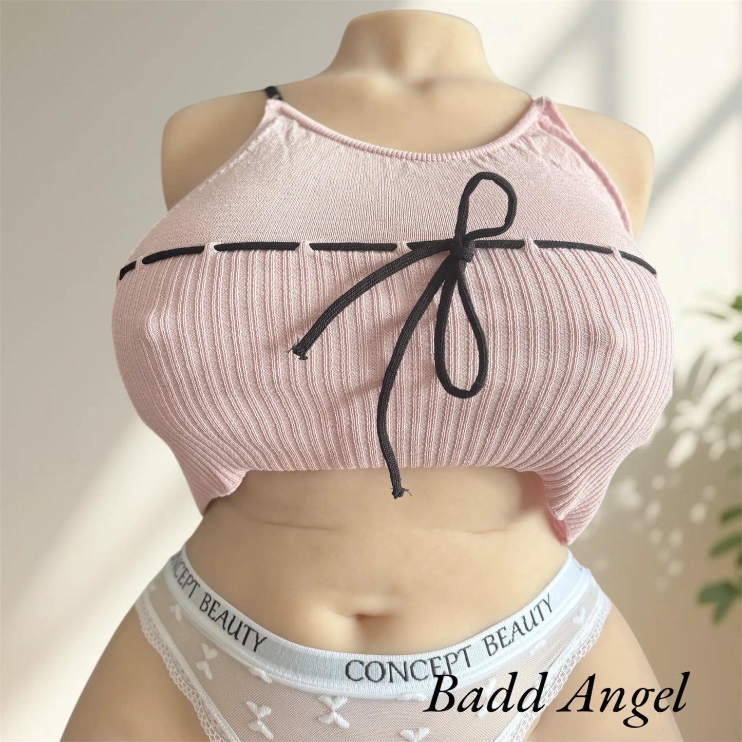 Badd Angel wearing a lace pink top