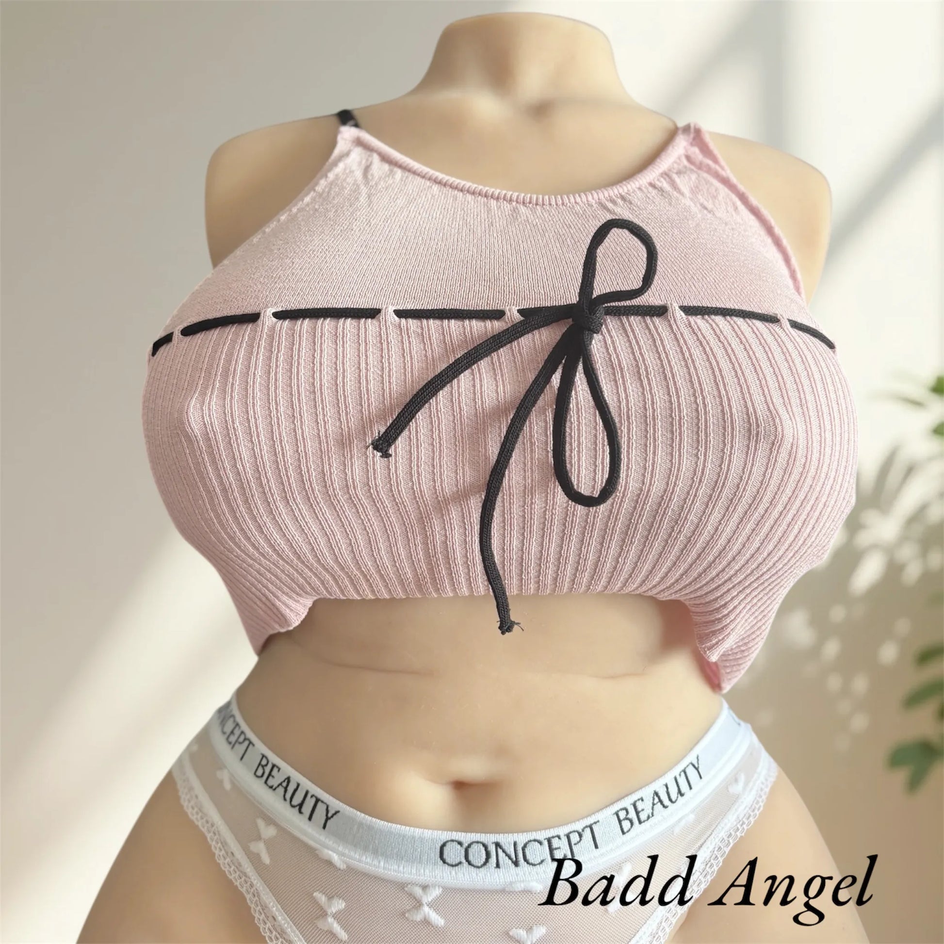 Badd Angel wearing a lace pink top